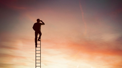 Businessman looks far for new business with binocular