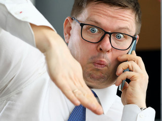 Male executive talking cellphone about bad consequences