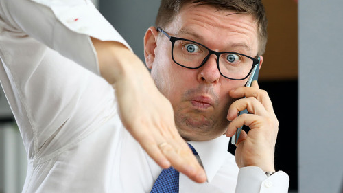 Male executive talking cellphone about bad consequences