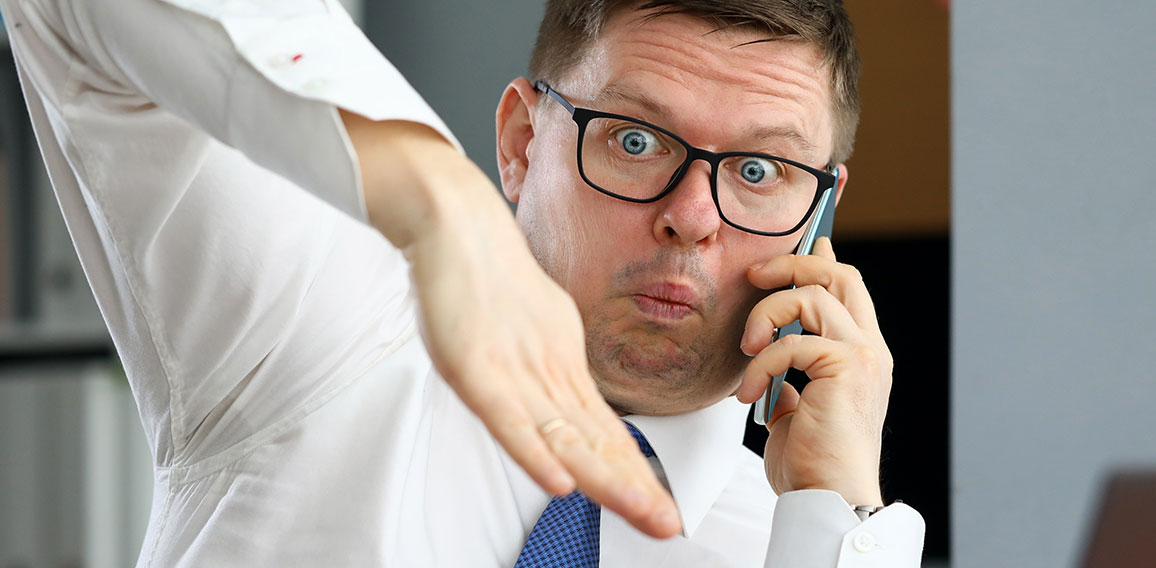 Male executive talking cellphone about bad consequences