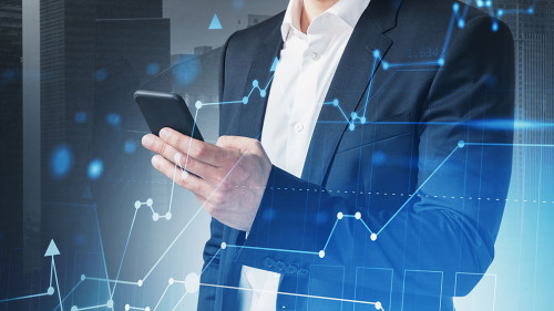 Man with smartphone in night city and graph