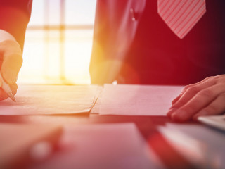 businessman signing documents