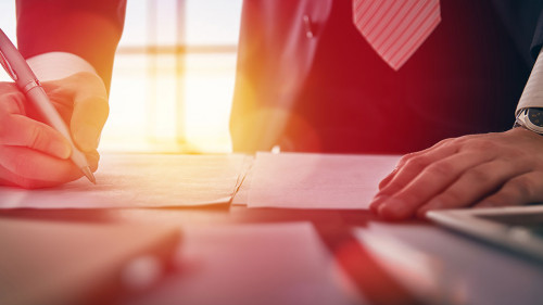businessman signing documents
