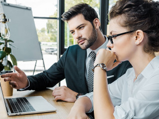 lawyers discussign work at workplace with laptop and femida in o