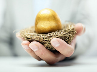 Retirement savings golden nest egg in businessman hand