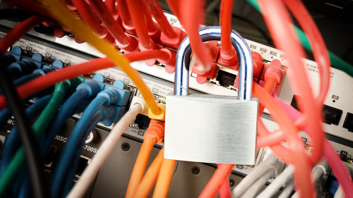 padlock on the colorful cables at a network server, safety conce