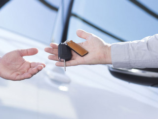 Panorama and close-up of car seller's hand with keys and buyer's