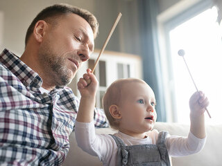 Cute little girl feeling happy palying with xylophone