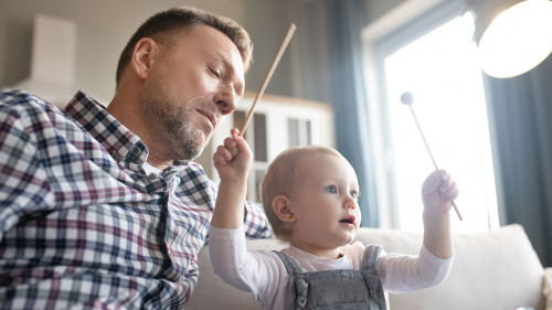 Cute little girl feeling happy palying with xylophone