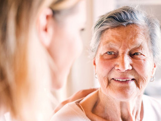 An elderly grandmother with an adult granddaughter at home.