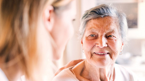 An elderly grandmother with an adult granddaughter at home.