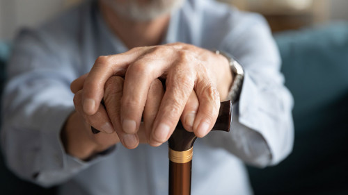 Close up of lonely old man with cane missing