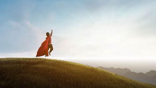 boy dreaming of being superhero looking at the city