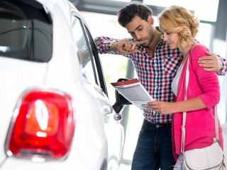 Happy couple chooses to buy a car