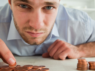 Desperate businessman counting his change