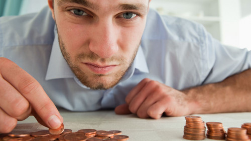 Desperate businessman counting his change