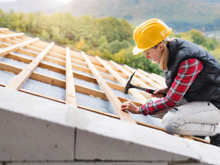 Young woman worker on the construction site.