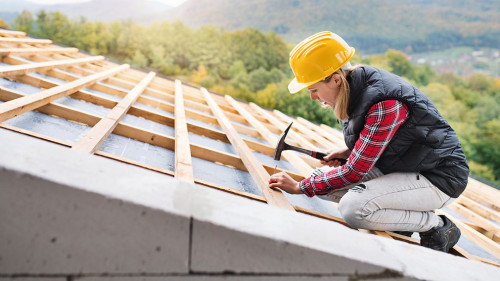 Young woman worker on the construction site.
