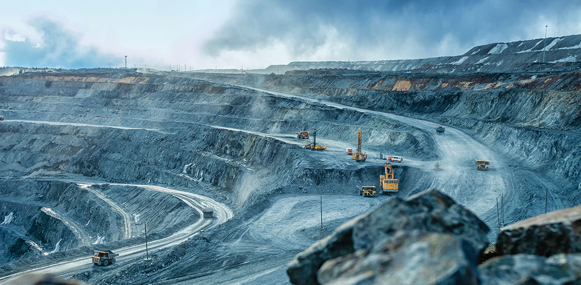 Work of trucks and the excavator in an open pit