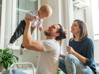 Young parents playing with baby