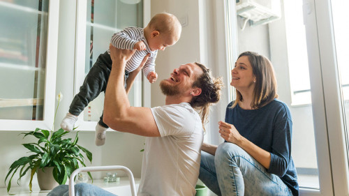 Young parents playing with baby