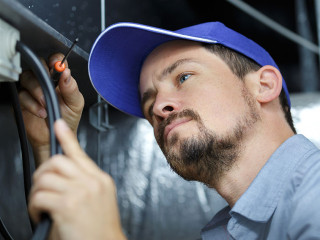 an electrician is fixing an electric cable