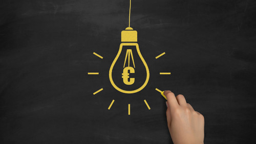 Euro Symbol Bulb Drawing with Chalk on Blackboard by Female Hand