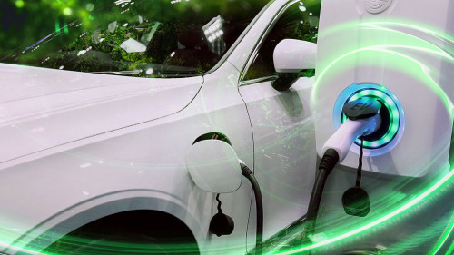 EV Car or Electric vehicle at charging station with the power cable supply plugged in on blurred nature with green energy power effect. Eco-friendly sustainable energy concept.