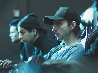 Serious man in cap working in database center