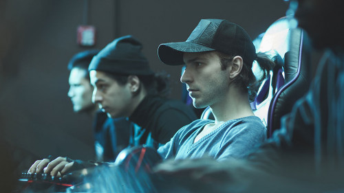 Serious man in cap working in database center