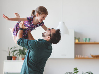Father's day. Happy family daughter hugs his dad