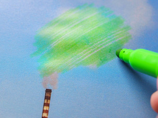 Man painting green pollution from a chimney