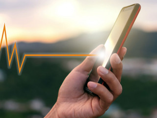 Woman hand holding smartphone with vital sign of heart beat back