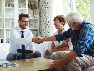 Financial advisor shaking hands with senior man