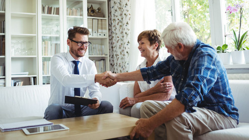 Financial advisor shaking hands with senior man