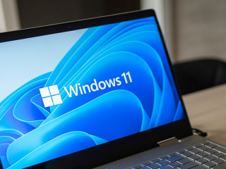 Windows 11 logo on laptop screen. A new operating system update from Microsoft