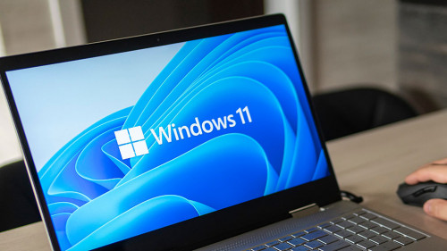 Windows 11 logo on laptop screen. A new operating system update from Microsoft