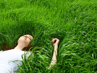 beautiful girl lying down of grass