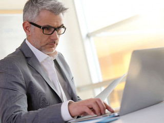 Businessman in office working on laptop