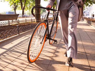 businessman walking with bicycle