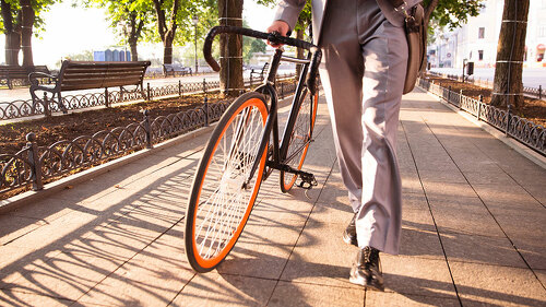 businessman walking with bicycle