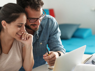 Husband and wife sitting at home and buying online stocks action