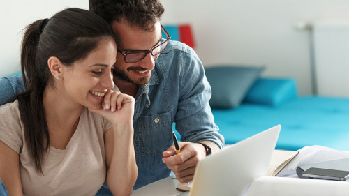 Husband and wife sitting at home and buying online stocks action