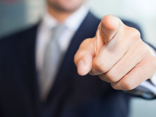 Businessman pointing his finger at you