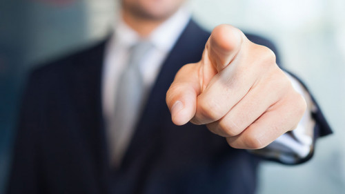 Businessman pointing his finger at you