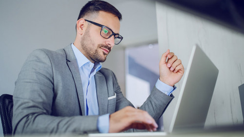Hardworking classy handsome businessman in suit and with eyeglas