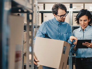 Female Inventory Manager Shows Digital Tablet Information to a W