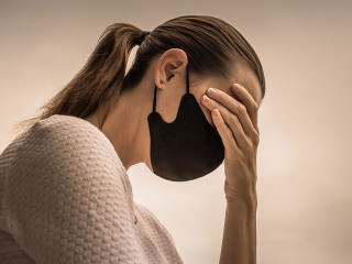 Stressed female wearing protective face mask. Coronavirus, fear,