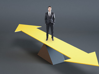 Young businessman standing on abstract balancing different direction arrow on gray background with mock up place. Choice, solution and mock up concept.