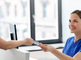 doctor and patient with credit card at hospital